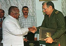 Iraqi Oil Minister, Lt.Gen. Amer Mohammed Rasheed, shakes hands with his Indian counterpart V.K. Ramamurther after signing trade cooperation contracts on Monday. 