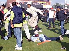An Indian fan is kicked and stamped on