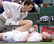 Jonas Bjorkman of Sweden undergoes treatment for a groin injury