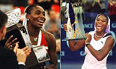 Serena Williams and Venus Williams displaying their trophies