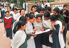Students discuss the question paper after the examination outside a centre in Chandigarh. The plus two CBSE examination began on Thursday 
