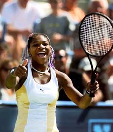 Serena Williams flashes a thumbs up as she celebrates her upset win over Lindsay Davenport
