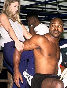 WBA and IBF Heavyweight Champion Evander Holyfield stretches during an open workout 