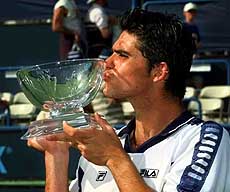 Australia's Mark Philippoussis kisses the trophy after he defeated the new No.1 ATP player Carlos Moya
