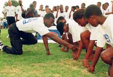 American athlete Michael Johnson gives instructions during a workshop in Soweto on Wednesday