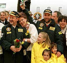 Round-the-World-balloonists Bertrand Piccard (3rd from right) with his wife Michelle (1st right) and Brian Jones (left) being held by his wife Joanna, after they returned to Switzerland on Monday being welcomed by family members and wellwishers gathered on the tarmac at Geneva airport. — AP/PTI