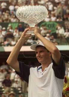Richard Krajicek of The Netherlands holds up the championship trophy after defeating Sebastien Grosjean of France