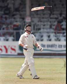 Australian batsman Michael Slater throws his bat as he returns to the pavilion after he was run out