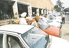 Buyers have a good look at the cars put up for sale at a car bazar in Chandigarh