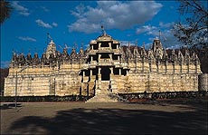 The huge temple as seen from outside looks like a viman with red flags aflutter in the wind