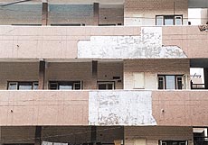A peeled-off portion of the facade of a balcony in the Housing Board colony in Sector 14 of Panchkula.