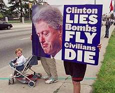 A Serbian-American woman carries a poster of President Clinton 