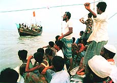 Rescue workers and relatives search and locate a capsized ferry