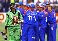 Kenya's Ravinda Shah (left) walks off after being caught behind by England's Alec Stweart off the bowling of Darren Gough 