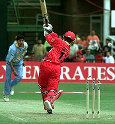 India's Ajit Agarkar (left) bowls Zimbabwe's Paul Strang out for 18, during their match against Zimbabwe at the Grace Road ground in Leicester on Tuesday