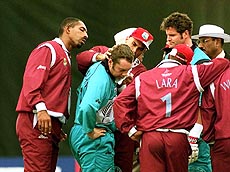 West Indies Phil Simmons (left) Jimmy Adams (2nd left) and Brian Lara (right) worry over New Zealand's Craig McMillan (center) after he was hit in the head by a ball during the Cricket World Cup match between West Indies and New Zealand at Southampton on Monday