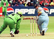 India's Sachin Tendulkar gets the ball past Kenyan wicket-keeper Kennedy Otieno on the way to his 140 not out in the World Cup match at Bristol 23 May 1999