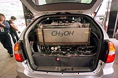 Japanese TV crews gather around a Nissan fuel cell vehicle mounted with a methanol reformer during a press gathering at the headquarters of Nissan Motor Co., Ltd. in Tokyo. 