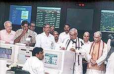 Sriharikota: Prime Minister A. B. Vajpayee congratulating the scientists after the successful launching of the PSLV-C2 rocket with three satellites