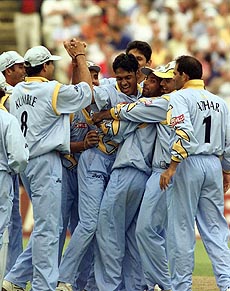 Debashish Mohanty (C) is congratulated by the Indian team after he claimed the wickets of England's Greame Hick and Alec Stewart during their Cricket World Cup match at Edgbaston 29 May 1999. 