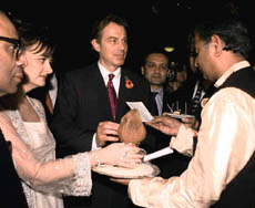  LONDON : Britain's Prime Minister Tony Blair and his wife Cherie receive a traditional Hindu greeting from Priest Nandakuwar (right) with host, S.P. Hinduja (left)  at the Festival of Lights Gala Event to promote multi-cultural understanding, at Alexandra Palace in London on Wednesday. AP/PTI