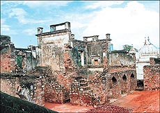 Ruins of a palace built by Akbar II (extreme right) is the small Moti Masjid built by Bahadur Shah I in 1709 AD