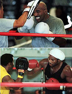 Evander Holyfield of Atlanta (top) and Lennox Lewis of England (bottom) practices with their trainer during a workout in Las Vegas on Monday. Both will fight on November 13 at the Thomas & Mack Centre in Las Vegas 