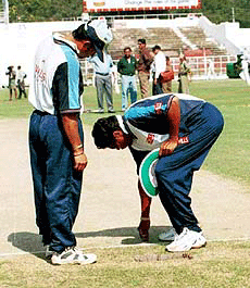 Sachin Tendulkar examining the pitch with coach Kapil Dev at Roop Singh stadium in Gwalior on the eve of one day match against New Zealand