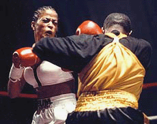 Laila Ali (left) jabs Shadina Pennybaker of Pittsburgh during their four-round bout at Mountaineer Race Track and Gaming Resort in Chester on Wednesday