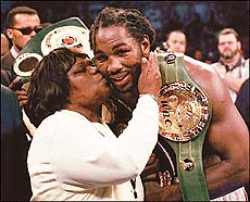 Lennox Lewis, right, of Britain, gets a kiss from his mother after defeating Evander Holyfield, of Atlanta, by way of unanimous decision for the undisputed world heavyweight championship at the Thomas & Mack Centre in Las Vegas on Saturday