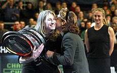 Tennis star Steffi Graf gets a kiss and an autographed tennis racket from Arantxa Sanchez Vicario, while Mary Pierce, right, watches during a ceremony honoring her retirement at the Chase Cahmpionships at Madison Square Garden in New York on Tuesday