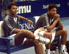 The doubles team of Leander Paes (left) and Mahesh Bhupati of India, sit on the bench after they were defeated in straight sets 6-3, 6-2, 6-2 by Alex O'Brien of Amarillo, Texas and Sebastien Lareau of Canada, for the ATP World Doubles Championship title in Hartford, Conn., on Sunday