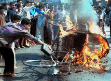 Bangladesh's main opposition party activists set fire to a tri-cycle rickshaw during a nationwide anti-government strike in Dhaka Thursday