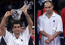 U.S. Tennis player Pete Sampras (left) holds the trophy after his victory in the final match against Andre Agassi (right) at the ATP Tennis World Championships in Hanover, Northern Germany on Sunday