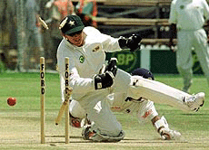 Zimbabwean captain and wicket keeper Andy Flower knocks down the stumps, to run out Sri Lanka's Ramesh Kaluwitharana on the third day of the Test Match between Zimbabwe and Sri Lanka at the Harare Sports Club, in Harare on Sunday