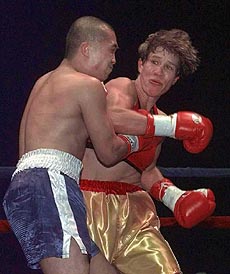Margaret McGregor, right, hits boxing opponent Loi Chow Saturday, during their bout in Seattle. McGregor won by decision