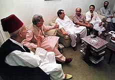 Nasar Ullah Khan, left, presides over a meeting of the Pakistan People's Alliance, the main opposition to deposed Pakistani Prime Minister Nawaz Sharif on Monday in Islamabad. 