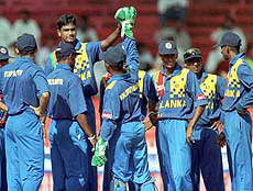Sri Lankan cricket players congratulate Nuwan Zoysa, third from left, after he dismissed Pakistan's Saeed Anwar in the fifth Sharjah Trophy match in Sharjah on Monday. 