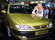 German supermodel Claudia Schiffer poses with a Citroen Xsara car during the Press preview day of The London Motor Show 1999, held at Earls Court, London, Tuesday. 