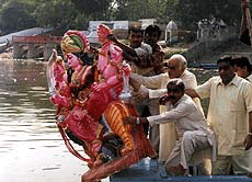 Former Union Minister Madanlal Khurana joins the immersion of goddess Durga's idol in the river Yamuna, in New Delhi on Tuesday. PTI photo