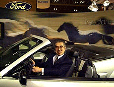 Japanese Prime Minister Keizo Obuchi grins as he gets into a Mustang convertible at the Ford Motor Co. booth during his inspection tour to the 33rd Tokyo Motor Show special guest day, Friday, in Makuhari, east of Tokyo.