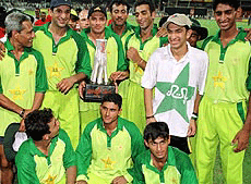 Pakistan cricket team poses with trophy in front of the cameras, after they won against Sri Lanka in the final match of the Sharjah Cup on Friday