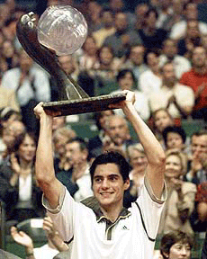 Nicolas Lapentti of Ecuador raises the trophy after defeating Australia's Lleyton Hewitt 6-3, 6-2 in the final of the Lyon Indoor Tennis Tournament, in Lyon, on Sunday