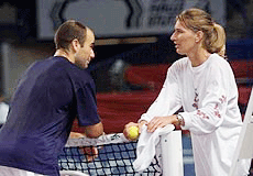 Andre Agassi of the USA, left, talks with his girlfriend, retired German tennis star Steffi Graf as they play a training session together in the Hanns-Martin-Schleyer indoor arena in Stuttgart, Germany on Tuesday