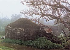 A dilapidated temple, dedicated to Shiva, is located next to a small natural lake