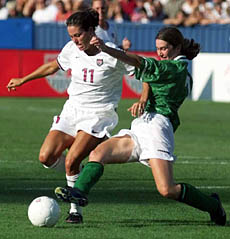 Julie Foudy (11) of the United States, vies for the ball with Ciera Grant (7) of Ireland, during the first half of an exhibition game at Foxboro Stadium in Foxboro, Mass. on Saturday