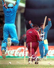 West Indies batsman Brain Lara, centre, gets bowled out at the Coca-Cola Singapore Challenge Finals against India