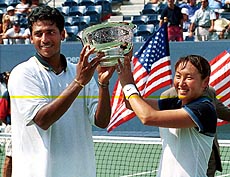 Mahesh Bhupathi (left) and Ai Sugiyama, of Japan, show off their trophy after defeating Kimberly Po and Donald Johnson, 6-4, 6-4 in their mixed doubles finals match at the U.S. Open tennis tournament in New York on Thursday