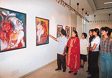 Visitors have a close look at Satwant Singh's paintings being exhibited at Alliance Francaise Art Gallery 