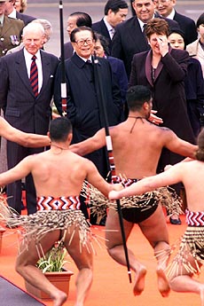 A traditional New Zealand “Maori” welcoming party performs a “Haka” or war dance as Chinese President Jiang Zemin (centre) looks on.